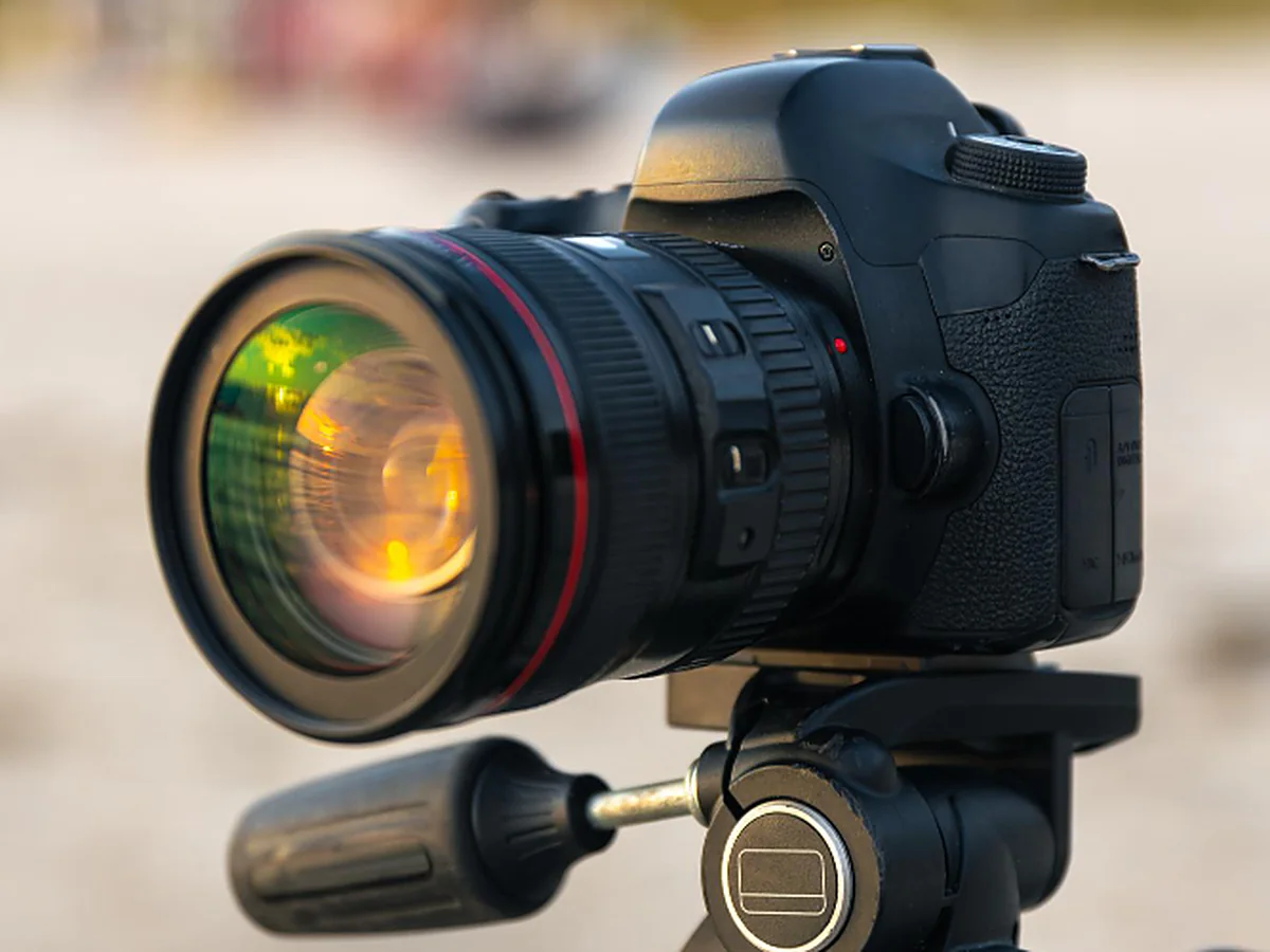 Camera and lens on a tripod in golden light